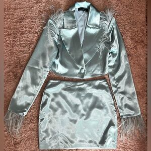 Powder blue satin suit with shoulder pads & feather details